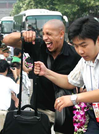 Brazil's soccer player Roberto Carlos (L) of Real Madrid arrives at a welcome ceremony at Xianghe town in Hebei Province, eastern Beijing July 20, 2005. Real Madrid starts a four-day tour to China on Wednesday and will face Beijing Guoan in a friendly match at Beijing Workers' Stadium on Saturday.