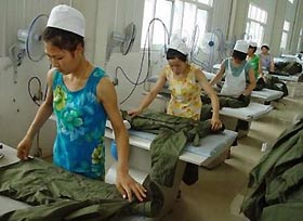 Chinese workers arrange clothes in a textile company in Huaibei in east China's Anhui province August 17, 2005.