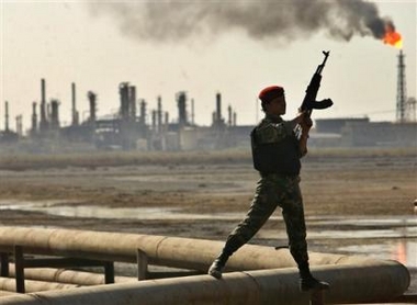 An Iraqi guard provides security at the Al-Shiaaba oil refinery and the pipeline near the southern Iraqi city of Basra, Sunday, Aug. 21, 2005. 