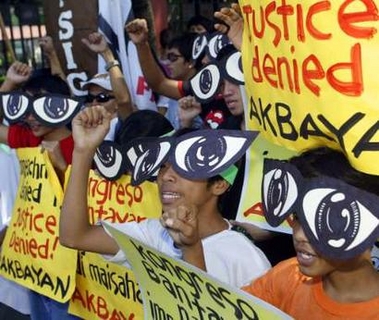 Filipino protesters shout slogans during a rally outside the House of Representatives in Quezon City, north of Manila, August 23, 2005. 