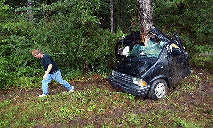 A man walks away from a car that crashed and killed an unidentified man who lost control of the vehicle as hurricane Katrina struck on the I-10 highway outside of Pensacola, Florida, August 29, 2005. Authorities in New Orleans ordered hundreds of thousands of residents to flee on Sunday as Hurricane Katrina strengthened into a rare top-ranked storm and barrelled towards the vulnerable U.S. Gulf Coast city for a second and more deadly assault on the Gulf Coast.
