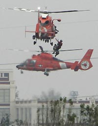A Coast Guard helicopter plucks a Hurricane Katrina survivor from a rooftop in New Orleans, September 1, 2005.