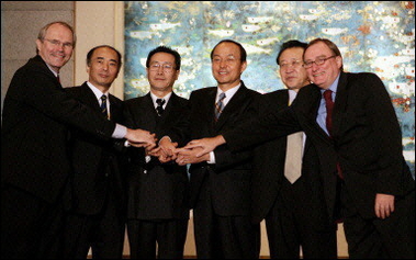 (L-R) United States Assistant Secretary of State Christopher Hill, Japanese delegation leader Kenichiro Sasae, Chinese Vice Foreign Minister Wu Dawei, South Korean Deputy Foreign Minister Song Min-soon, North Korea's chief negotiator Kim Gye Gwan and Russian Deputy Foreign Minister Alexander Alexeyev join hands at the close of six-party talks over North Korea's nuclear program at the Diaoyutai State Guest House in Beijing.