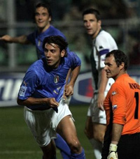 Italy's Christian Zaccardo, left, celebrates after scoring to Slovenia's goalie Borut Mavric, right, during their 2006 Soccer World Cup qualifying match in Palermo, Sicily, Saturday, Oct. 8, 2005.