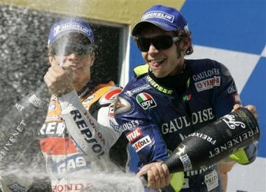 Italian MotoGP world champion rider Valentino Rossi, right, and American Nicky Hayden celebrate on the podium after the Australian Motorcycle Grand Prix at Phillip Island, Sunday, Oct. 16, 2005. Rossi won the race and Hayden came second. (AP