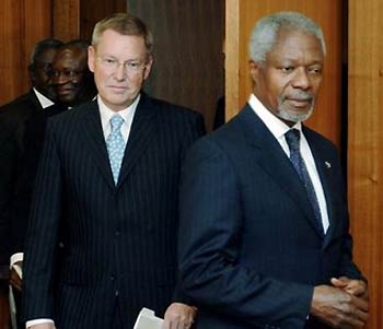 U.N. investigator Detlev Mehlis, left, holds a copy of the report on the assassination of former Lebanese Premier Rafik Hariri as he arrives for a meeting with United Nations Secretary General Kofi Annan, right, in Annan's office at the United Nations headquarters, Thursday Oct. 20, 2005.