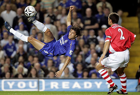 Chelsea's Hernan Crespo (L) takes a shot on goal as Charlton Athletic's Luke Young looks on during their English League Cup third round soccer match at Stamford Bridge in London October 26, 2005.