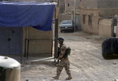 In this picture released Sunday, Nov. 6, 2005, by the US Marine Corps, an Iraqi Army soldier patrols the streets of Husaybah, Iraq, Sunday, Nov. 6, 2005, after clearing this section of town of insurgents during Operation Steel Curtain.