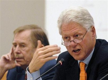 Former U.S. President Bill Clinton, right, makes his speech as former Czech President Vaclav Havel listens during the evening plenary session of an annual conference of the Club of Madrid in Prague, on Friday, Nov 11, 2005.