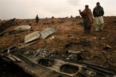 Afghan villagers walk at the site of a plane crash around 30 kilometers (19 miles) northwest of Kabul, Afghanistan, Friday, Nov. 11, 2005.