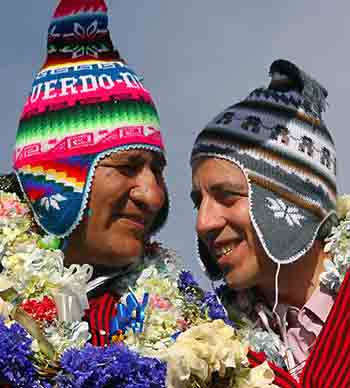 Bolivian presidential candidate for the indigenous Movement Toward Socialism (MAS) party, Evo Morales (L) chats with his vice-presidential running mate Alvaro Garcia Linera during a rally in Achacachi, some 90km (55 miles) northwest from La Paz, November 14, 2005. Morales is well ahead in the polls running up to the elections scheduled for December 18.