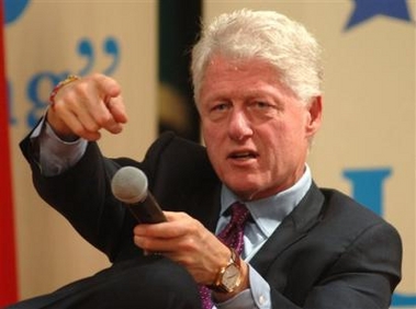 Former U.S. President Bill Clinton, acknowledges the students of the American University Dubai, during his visit to mark the 10 anniversary celebration of AUD, in Dubai, United Arab Emirates, Wednesday, Nov. 16, 2005. (AP