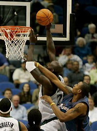 Minnesota Timberwolves' Kevin Garnett goes up for two as he is fouled by Washington Wizards' Caron Butler in the second quarter Thursday, Nov. 17, 2005, in Minneapolis.