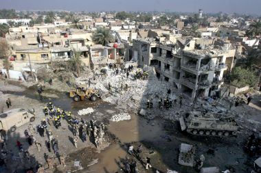 Iraqi emergency workers work to clear rubble from the site of a collapsed building in central Baghdad after two early morning explosions, November 18, 2005.