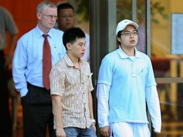 Khao Nguyen Tuong (R), brother of convicted Australian drug smuggler Nguyen Tuong Van, and lawyer Julian McMahon (L) leave Changi prison after Nguyen's execution in Singapore December 2, 2005.