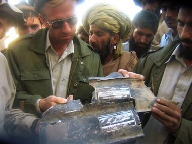 People show wreckage of a missile they found in the house where authorites reportedly killed five people including a key associate of al-Qaida Hamza Rabia, Thursday in Hesory 25 kilmeters (15 miles) east of Miran Shah in Pakistani tribal along the Afghanistan border, Sunday, Dec 4, 2005.