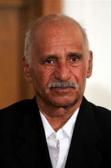 In this image cleared by the US military, Muhammed Hamza al-Zubaydi, retired Iraqi revolutionary command council member, appears in a courtroom at Camp Victory, a former Saddam palace on the outskirts of Baghdad, Thursday, July 1, 2004.