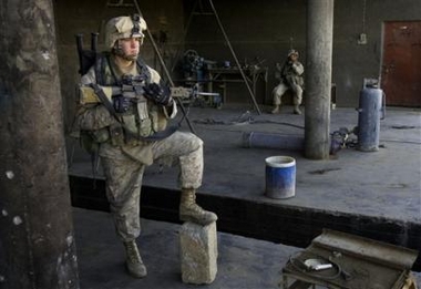 U.S. Marine Lance Cpl. Philip Schrock of Greenwood, Delaware pauses during a patrol in Karabilah, Iraq, seven miles from Syria, Wednesday, Dec. 7, 2005.