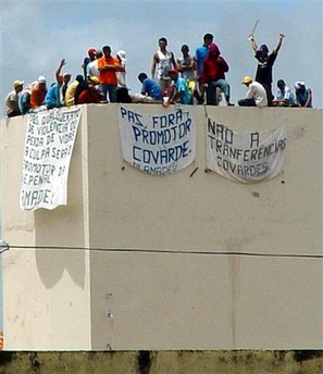 Rioting prisoners stand on top of the Urso Branco Penitentiary complex near the Rondonia state capital of Porto Velho, 1,520 miles northwest of Sao Paulo, December 27, 2005.