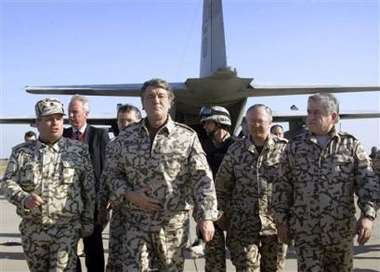 Ukrainian President Viktor Yushchenko, second left, visits a military base where Ukrainian troops station near Kut, Iraq, Monday, Dec. 26, 2005.