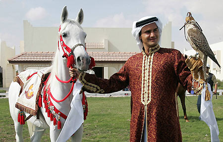 Tennis player Roger Federer of Switzerland poses while wearing traditional Qatari clothes, during the second day of the Qatar Open tennis tournament, in the outskirts of Doha January 3, 2006.[Reuters] 