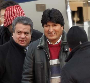 Bolivian President-elect Evo Morales (C) walks towards to his car after arriving at Beijing International Airport January 8, 2006. Morales arrived in China on Sunday, his latest stop on a global tour to discuss exploiting the country's massive natural gas reserves and seek aid for South America's poorest economy.