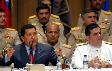 In this photo released by Venezuela's Miraflores Press, Venezuela's President Hugo Chavez, left, speaks at the inauguration of the new military academic year as his Defense Minister Orlando Maniglia sits to his right in Caracas, Venezuela, Tuesday, Jan. 10, 2006. 