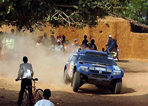 Spanish driver Carlos Sainz and German co-driver Andreas Schulz steer their Volkswagen Touareg through a village during the tenth stage of the Dakar Rally between Kiffa, Mauritania, and Kayes, Mali, Tuesday Jan 10, 2006.