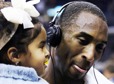 Los Angeles Lakers' Kobe Bryant holds his daughter Natalia after his 81-point performance against the Toronto Raptors during their NBA game in Los Angeles January 22, 2006. Bryant set a personal career single-game scoring high, and the performance is the second-highest single scoring total in NBA history.