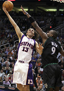 Phoenix Suns' Steve Nash (13) of Canada lays up a shot against Minnesota Timberwolves Justin Reed during fourth period NBA action in Phoenix, Arizona, February 6, 2006. Minnesota defeated Phoenix 103-101.