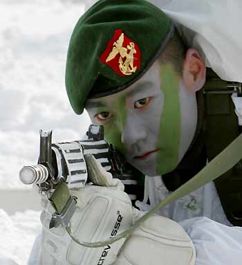 A South Korean marine takes aim during an annual severe winter season drill, to improve combat abilities in cold weather and heavy snowfall, in Pyongchang, about 180km (113 miles) east of Seoul, February 8, 2006.