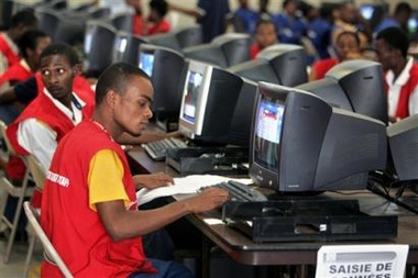 Election workers process balloting results inside the vote tabulation center, in Port au Prince, Haiti, Thursday, Feb. 9, 2006.
