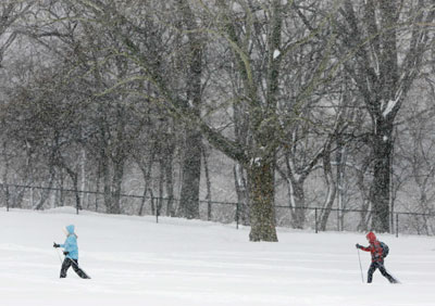 Skiers stride through deep snow in New York's Central Park during a snowstorm, February 12, 2006. The biggest snowstorm of the season belted the northeastern United States on Sunday with whiteout conditions and flashes of lightning, forcing airports to close, snarling traffic and bringing joy to ski resorts. As much as 22.8 inches (57.9 cm) of snow fell in New York's central park, the second heaviest snowfall on record, topped only by a blizzard in 1947, said the National Weather Service.