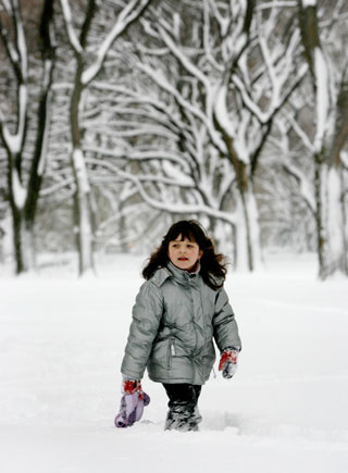 A girl walks through deep snow in New York's Central Park during a snowstorm, February 12, 2006. The biggest snowstorm of the season belted the northeastern United States on Sunday with whiteout conditions and flashes of lightning, forcing airports to close, snarling traffic and bringing joy to ski resorts. As much as 22.8 inches (57.9 cm) of snow fell in New York's central park, the second heaviest snowfall on record, topped only by a blizzard in 1947, said the National Weather Service.