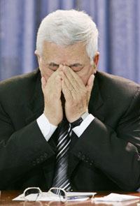 Palestinian President Mahmoud Abbas reacts during the swearing-in of the new Palestinian parliament at the Palestinian Authority headquarters in the West Bank city of Ramallah February 18, 2006. Hamas took over as the dominant party in the Palestinian parliament on Saturday and President Mahmoud Abbas challenged the militant Islamist group to recognise peace deals with Israel and maintain a truce.