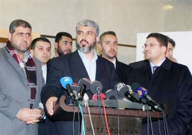 Khaled Mashaal, exiled political leader of Hamas, is surrounded by Turkish and Palestinian security agents as he speaks to the media during a short news conference before leaving for the airport in Ankara, Turkey Friday, Feb. 17, 2006. Mashaal's visit to the Turkish capital has triggered a new diplomatic rift between U.S allies Israel and Turkey. (AP Photo/Burhan Ozbilici) Email Photo Print Photo