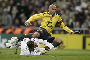 Arsenal's Thierry Henry fights for the ball with Real Madrid's Sergio Ramos during their Champions League first knockout first leg soccer match at Santiago Bernabeu stadium in Madrid, February 21, 2006.