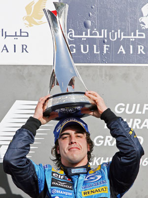 Renault Formula One driver Fernando Alonso of Spain displays his trophy on the podium after winning the Bahrain Formula One race at the Sakhir racetrack in Manama March 12, 2006.