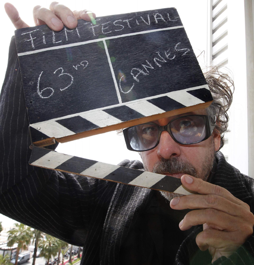 Tim Burton holds a film clapper in Cannes
