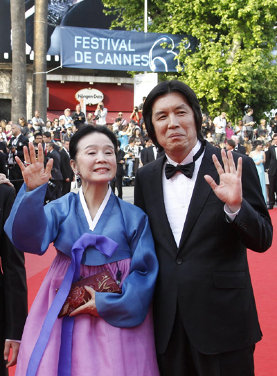 Cast members pose on red carpet for screening of film Poetry