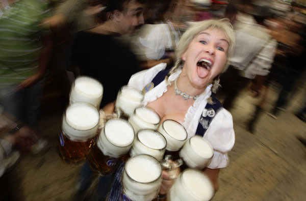 A waitress carries the traditional 1-litre beer mugs at the opening of the world's biggest beer festival, the Munich Oktoberfest, at the Theresienwiese in Munich, September 17, 2011. World's biggest beer fest opens in Munich