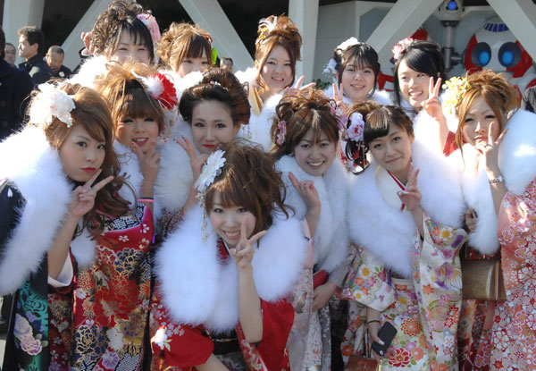 Women in kimonos pose for a photo during their Coming of Age Day event in Chiba, Japan, on Jan 9, 2012. 'Coming of Age Day' with record low number of new adults