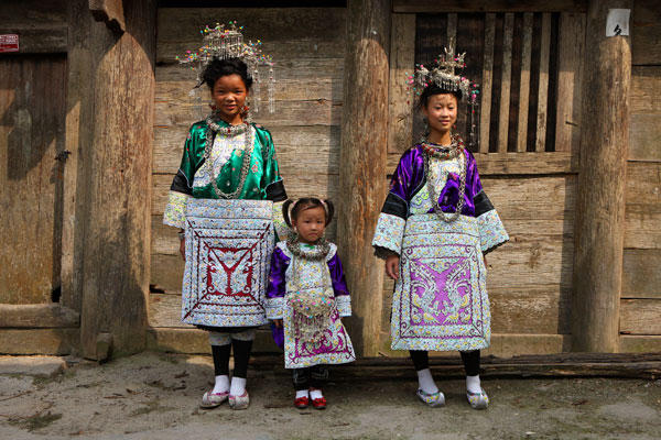 Wanhui (right), Jiangyun (left) and their little niece Luting dressed up in traditional Dong attire. Wanhui and her sister's splendid attire