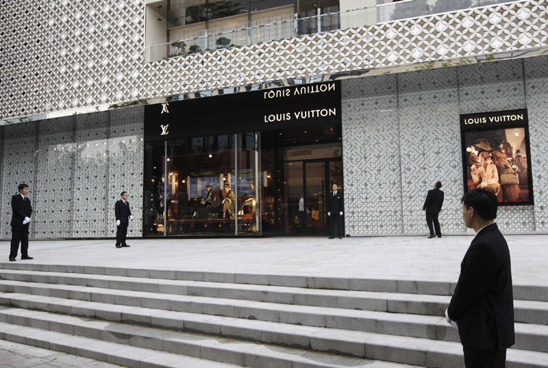 Security guards stand in front of the soon to be opened largest Louis Vuitton store in China in Shanghai, July 18, 2012. Reuters images of the year 2012 - China