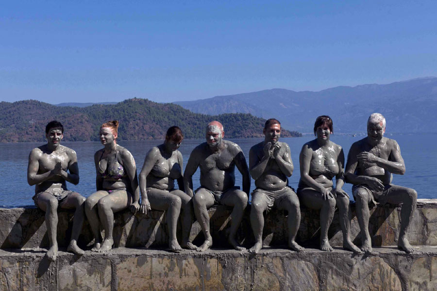 Visitors enjoy mud bath in a bathing spot in Dalyan of Turkey, on Sept 24, 2012. Mud bath in Dalyan is famous in Turkey and all around the world, attracting thousands of visitors every year during the tourist season. Xinhua world images of the year 2012