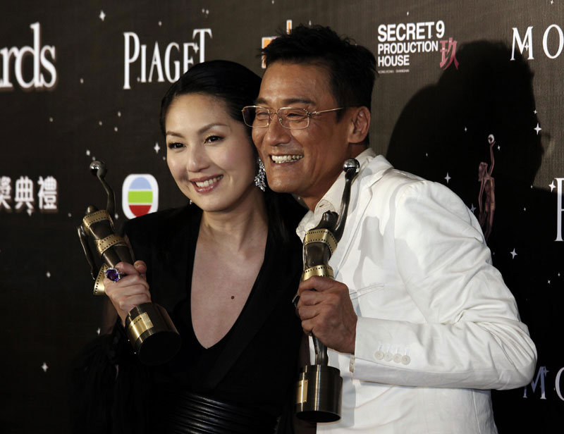 Hong Kong actor Tony Leung Ka-fai and actress Miriam Yeung pose with their Best Actor and Best Actress awards backstage at the Hong Kong Film Awards presentation ceremony in Hong Kong, April 13, 2013. 'Cold War' sweeps Hong Kong Film Awards