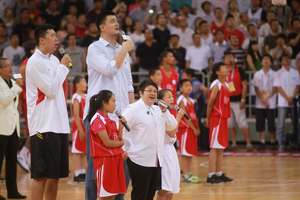 Yao Ming, Chinese national team's Wang Zhizhi, back left, and Chinese pop singer Han Hong, front center, sing ahead of a charity basketball match between the NBA All-star team and Chinese National team in Beijing, July 1, 2013. Yao Ming, McGrady team up for charity