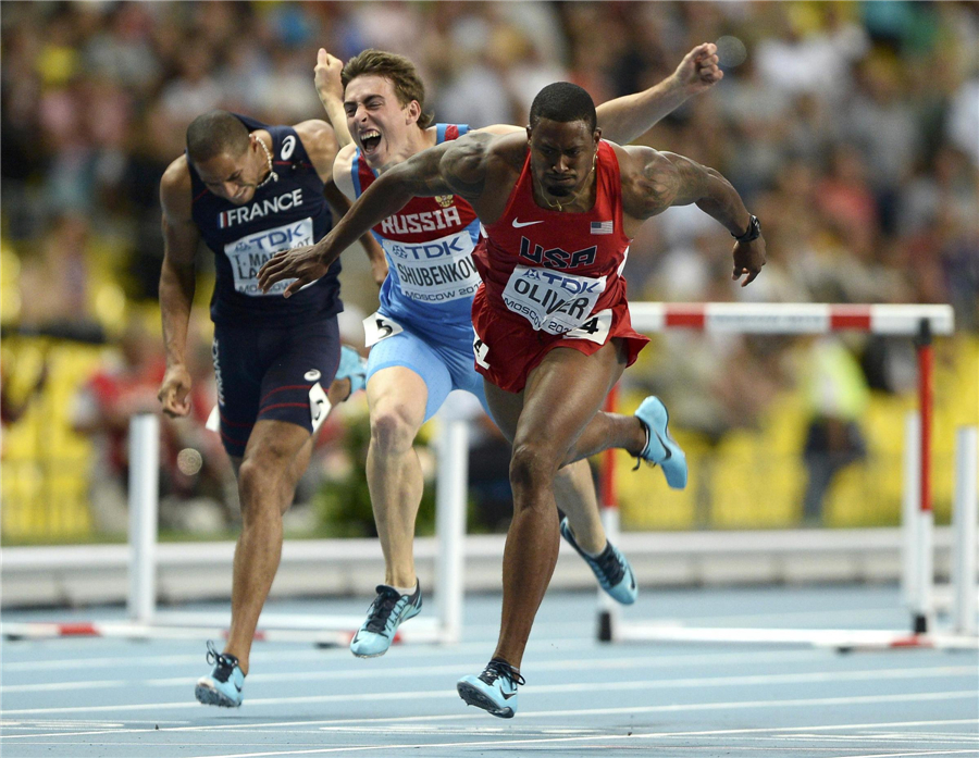 David Oliver (C) of the U.S. crosses the finish line to win the men's 110 metres hurdles final Faces of triumph and defeat at athletics worlds