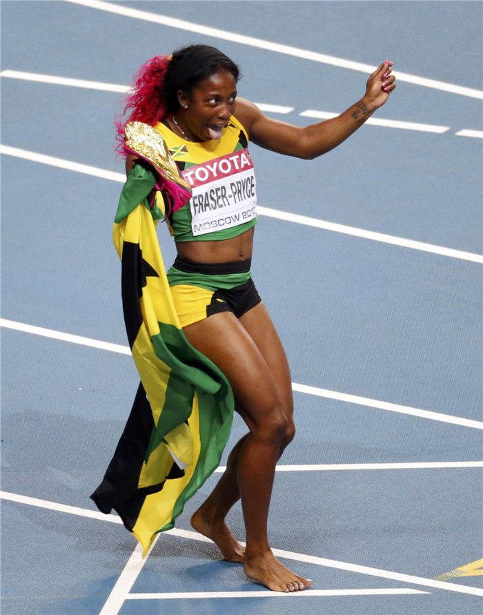 Shelly-Ann Fraser-Pryce of Jamaica celebrates after winning the women's 100 metres Faces of triumph and defeat at athletics worlds
