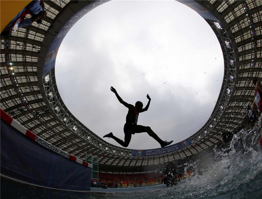Paul Kipsiele Koech of Kenya jumps a water obstacle in the men's 3000 metres steeplechase heat during the IAAF Faces of triumph and defeat at athletics worlds